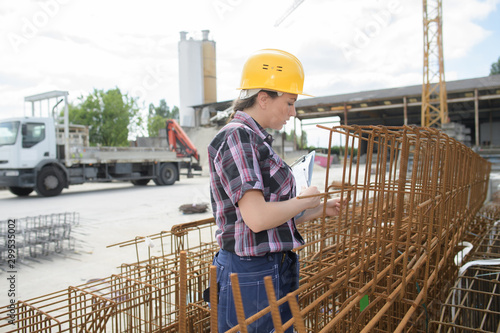 female construction worker working with metal structure