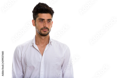 Portrait of young handsome bearded Persian businessman