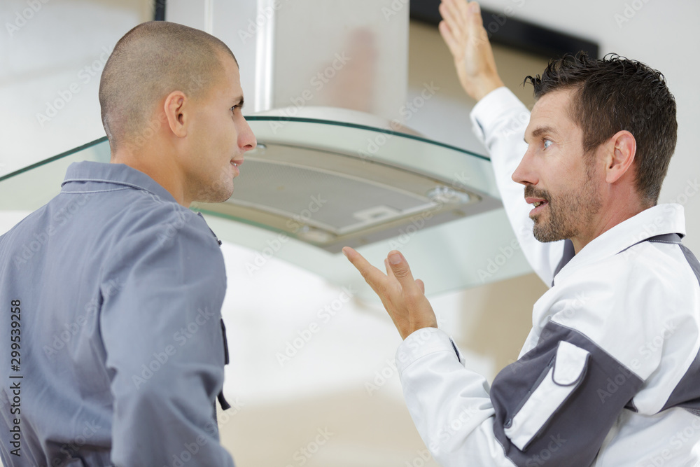 supervisor telling off his worker on installation supervisor telling off his worker on installation