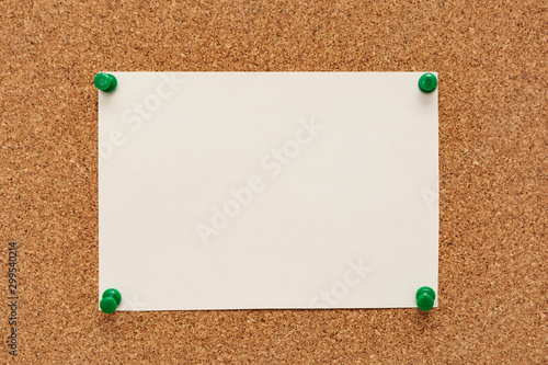 Note paper swith push pins on cork board. Empty paper pages for notes copy space photo