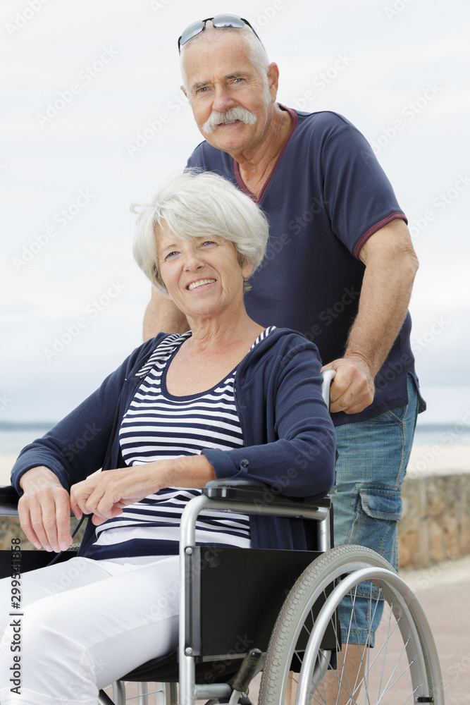 husband and senior disabled wife in wheelchair husband and senior disabled wife in wheelchair