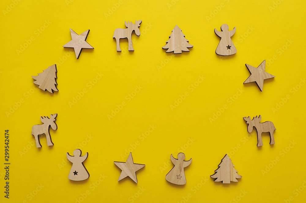Wooden christmas toy on yellow color background.