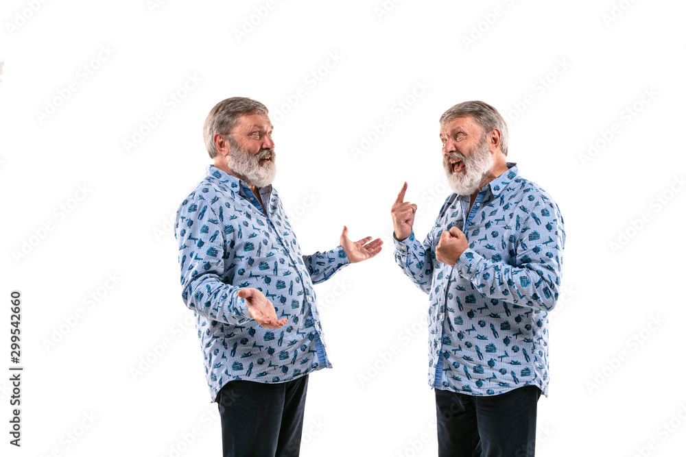 Senior man arguing with himself on white studio background. Concept of human emotions, expression, mental issues, internal conflict, split personality. Half-length portrait. Negative space. Pointing. Senior man arguing with himself on white studio background. Concept of human emotions, expression, mental issues, internal conflict, split personality. Half-length portrait. Negative space. Pointing.