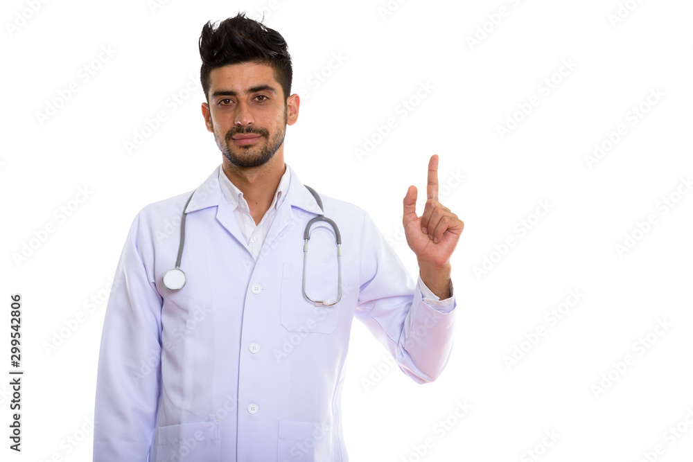 Portrait of young handsome bearded Persian man doctor