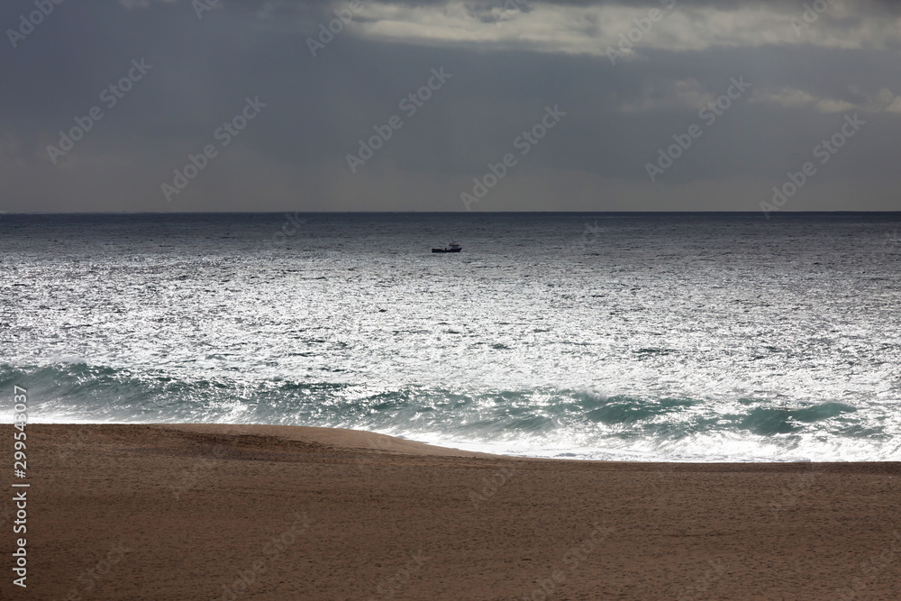 Landscape with a small boat in the ocean Landscape with a small boat in the ocean