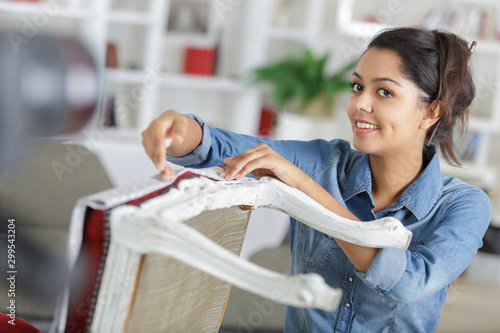 woman renovating a chair and filming her progress