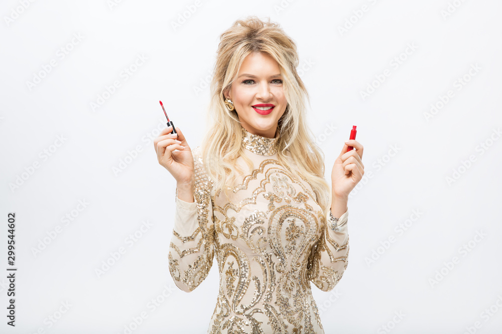 girl in a brilliant dress holds lipstick in her hands isolated on a white background girl in a brilliant dress holds lipstick in her hands isolated on a white background