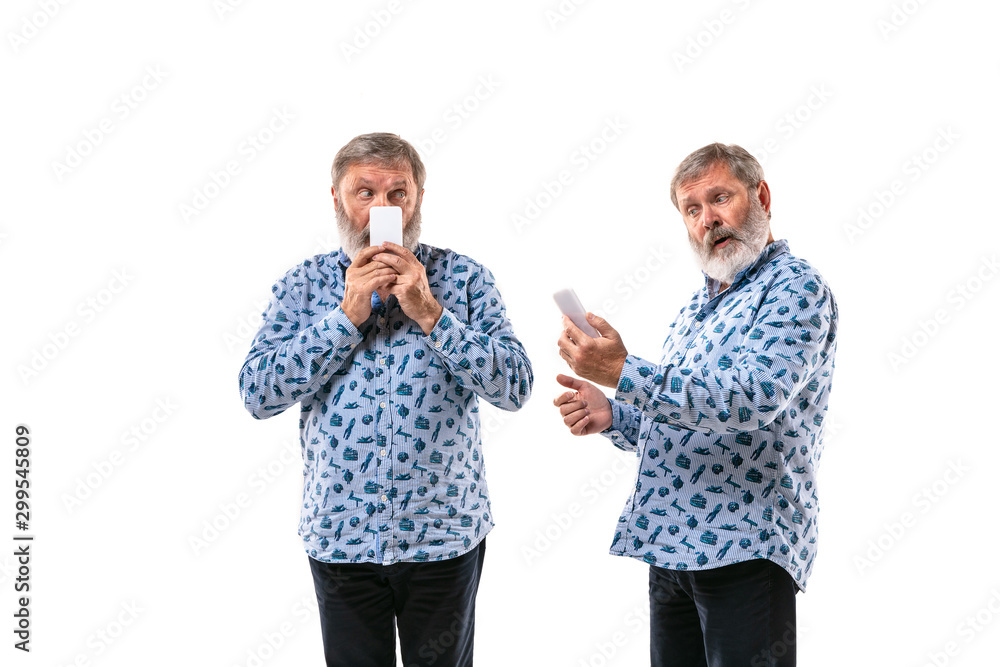 Senior man arguing with himself on white studio background. Concept of human emotions, expression, mental issues, internal conflict, split personality. Half-length portrait. Negative space. Secrets. Senior man arguing with himself on white studio background. Concept of human emotions, expression, mental issues, internal conflict, split personality. Half-length portrait. Negative space. Secrets.