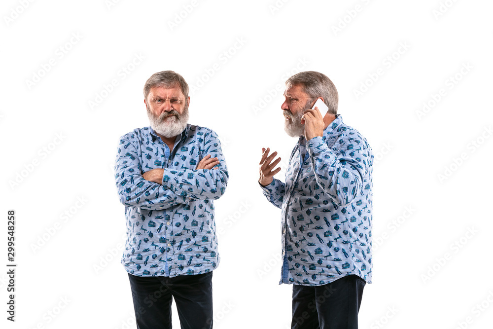 Senior man arguing with himself on white studio background. Concept of human emotions, expression, mental issues, internal conflict, split personality. Half-length portrait. Negative space. Gremaces. Senior man arguing with himself on white studio background. Concept of human emotions, expression, mental issues, internal conflict, split personality. Half-length portrait. Negative space. Gremaces.