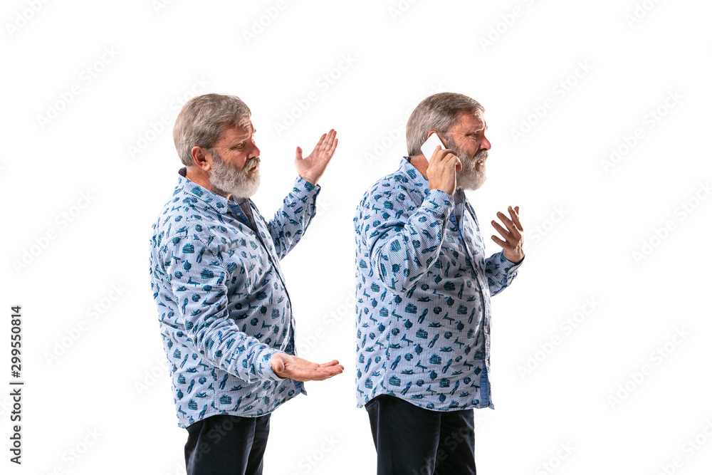 Senior man arguing with himself on white studio background. Concept of human emotions, expression, mental issues, internal conflict, split personality. Half-length portrait. Negative space. Disturbed. Senior man arguing with himself on white studio background. Concept of human emotions, expression, mental issues, internal conflict, split personality. Half-length portrait. Negative space. Disturbed.