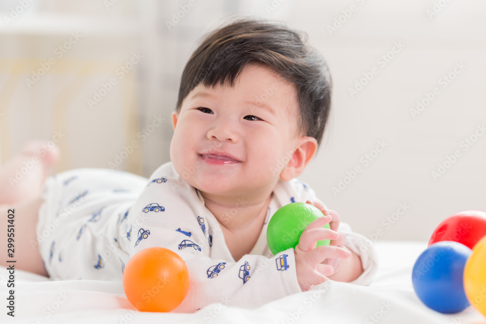 Happy cute adorable Asian baby boy with toys and smiley face. Happy cute adorable Asian baby boy with toys and smiley face.