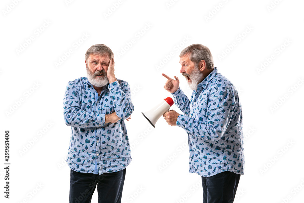 Senior man arguing with himself on white studio background. Concept of human emotions, expression, mental issues, internal conflict, split personality. Half-length portrait. Negative space. Mouthpeace Senior man arguing with himself on white studio background. Concept of human emotions, expression, mental issues, internal conflict, split personality. Half-length portrait. Negative space. Mouthpeace