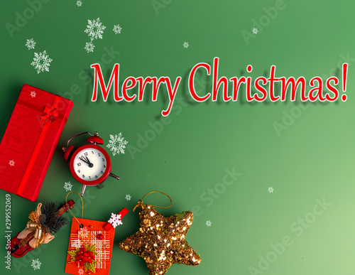 Wallpaper Mural Merry Christmas. Red gift box, clock, Christmas toys on a green background with snowflakes. Place for text. Torontodigital.ca