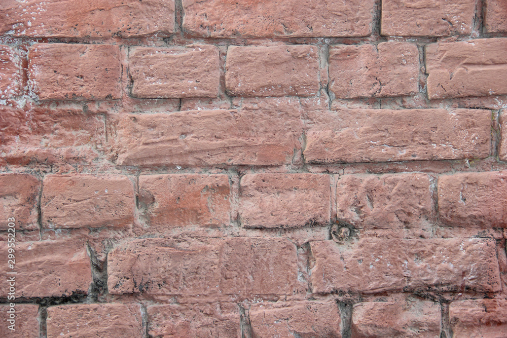 Obraz premium Texture of a brick wall coated with pink paint