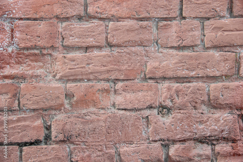 Texture of a brick wall coated with pink paint