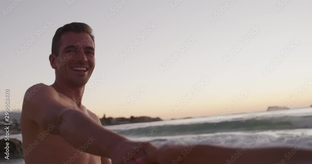 Young adult couple relaxing at the seaside Young adult couple relaxing at the seaside