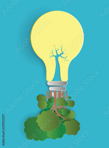 barren tree is die inside light bulb with a forest growing under. Environment, eco technology and energy concept.