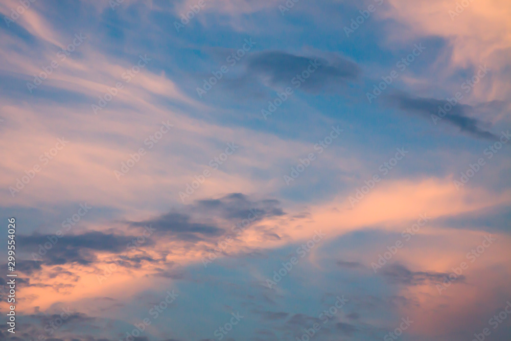 Fototapeta premium Sky background, deep blue with red toned clouds texture