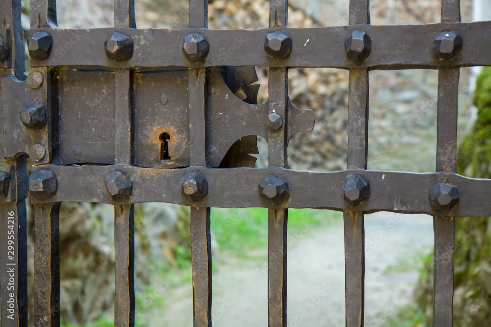 Old lock detail on iron bars. Pernstej Castle, Czech Republic Old lock detail on iron bars. Pernstej Castle, Czech Republic