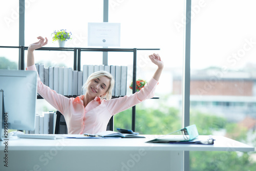 Relax working.  Business young women raise hand and relax after job working hard.  People celebrating growth work for success  and together report. Partner happy with your work. Business Concept photo