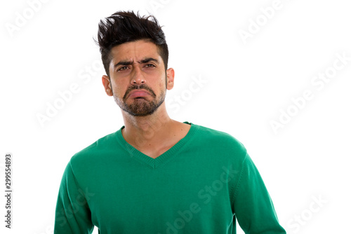 Studio shot of young Persian man looking sad