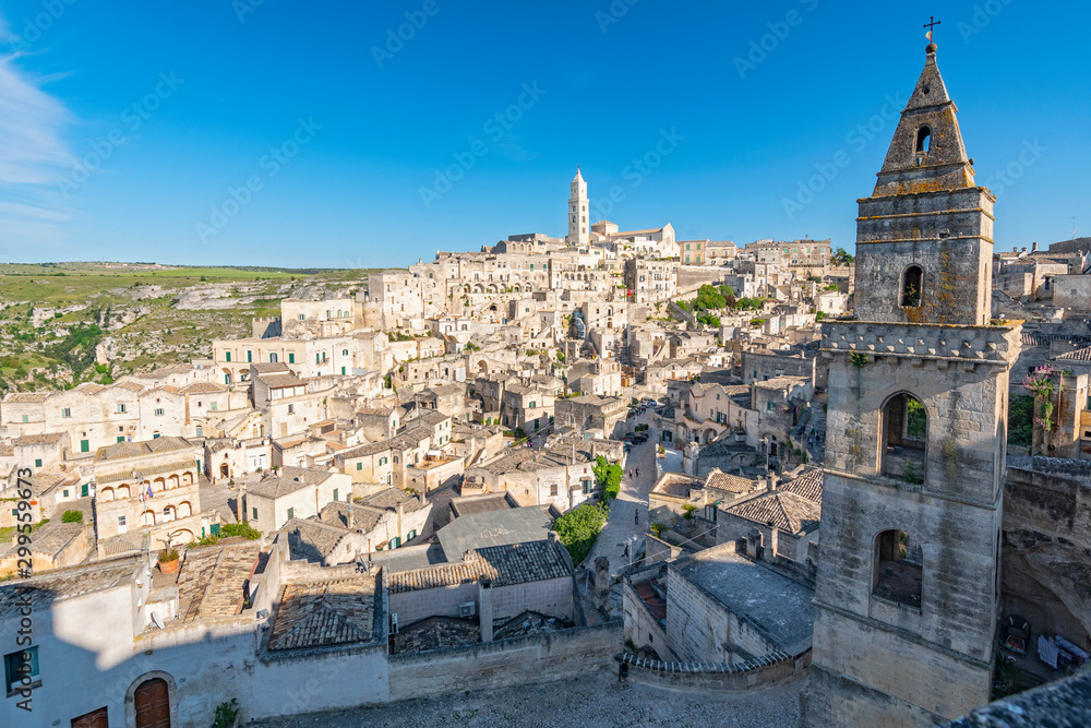 Obraz premium View of the ancient town and historical center called Sassi, perched on rocks on top of hill, Matera, Basilicata, Italy.