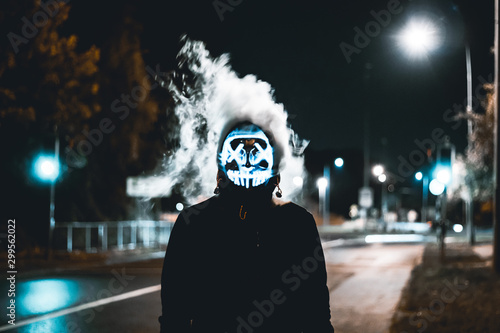 Scary purge mask with smoke in the streets. Stock Photo | Adobe Stock