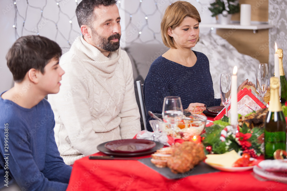 Portrait of happy family having christmas dinner at home