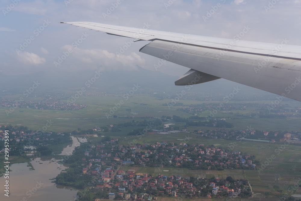 Wing aircraft, sky background and the city of Hanoi Vietnam Wing aircraft, sky background and the city of Hanoi Vietnam