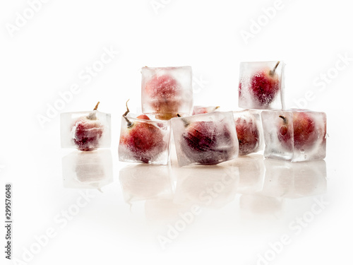 Grape inside ice on white background