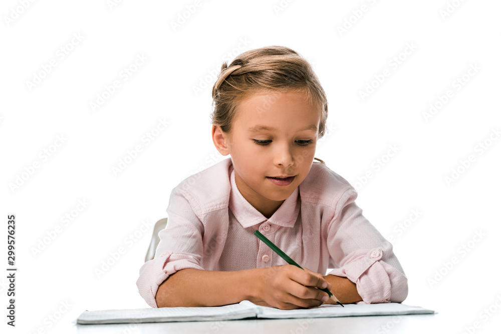 happy schoolkid smiling and holding pencil near notebook isolated on white happy schoolkid smiling and holding pencil near notebook isolated on white
