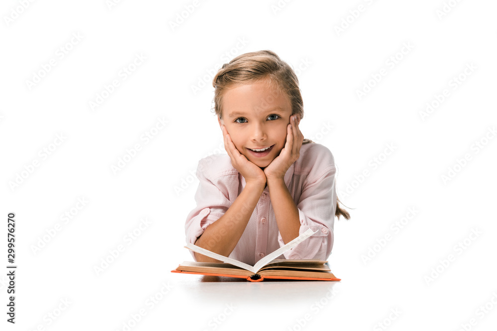 happy schoolkid smiling near book on white happy schoolkid smiling near book on white