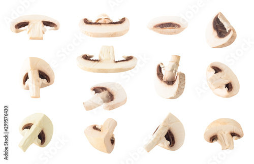 Set of slices and quarters of champignon mushrooms isolated on white background