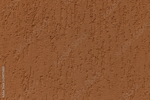 Rough brown rough surface texture background. Painted wall. Decorative brown stucco with scratches. Close-up, horizontal, cropped shot. The concept of design and construction.