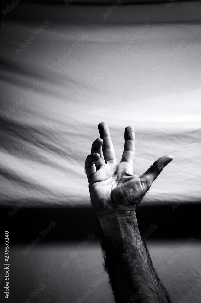 Black and white image of man's arm reaching into the image with right ...