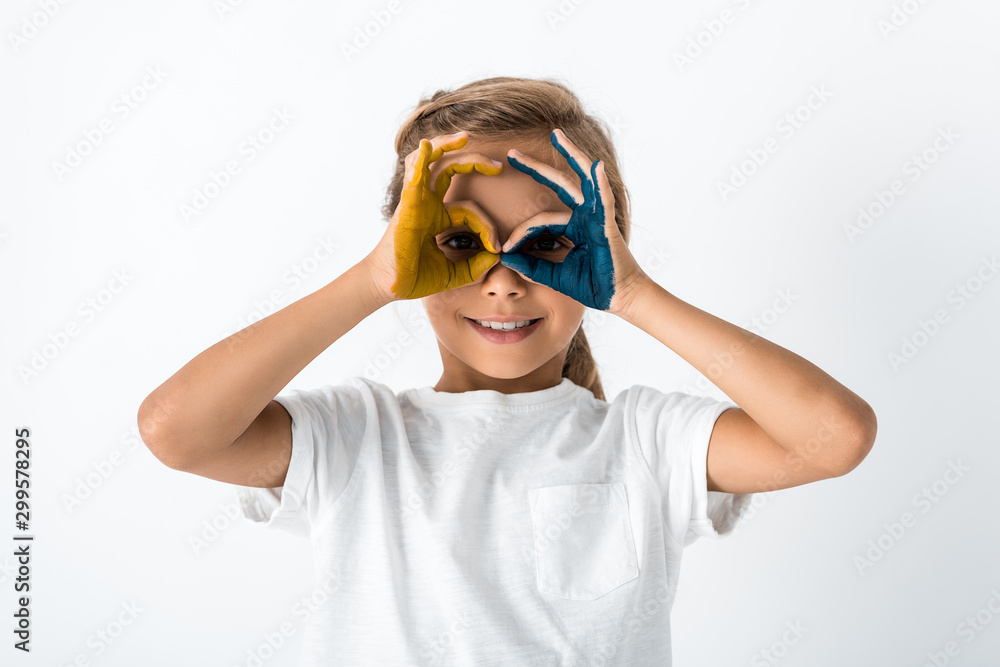 cheerful kid showing ok sign while covering face isolated on white cheerful kid showing ok sign while covering face isolated on white