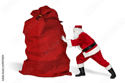 classic traditional crazy funny santa claus on exhausting delivery service. pushing huge giant big red bag with christmas gift present  isolated white background photo