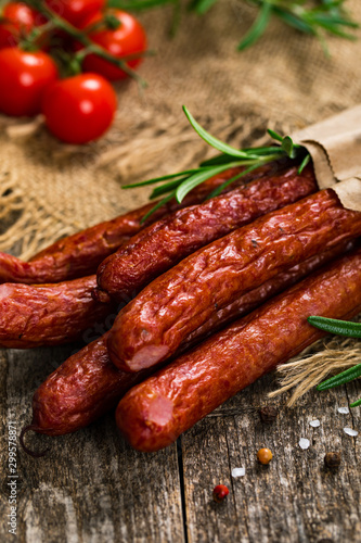 Thin Dry Smoked Polish Sausage on Wooden Background. Selective focus.