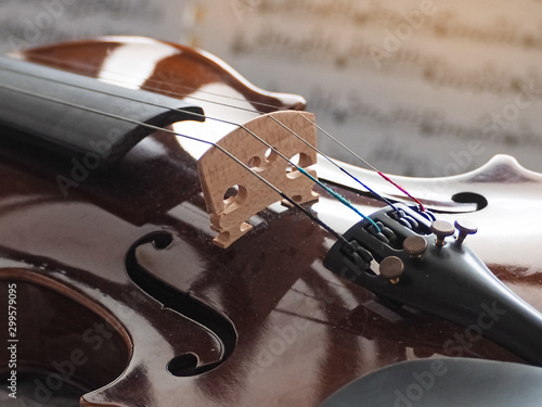 Closeup front side of wooden violin,vintage and art tone,blurry light around
