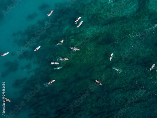 Aerial drone shot view of surfers in pacific ocean near Waikiki beach, Honolulu, Hawaii