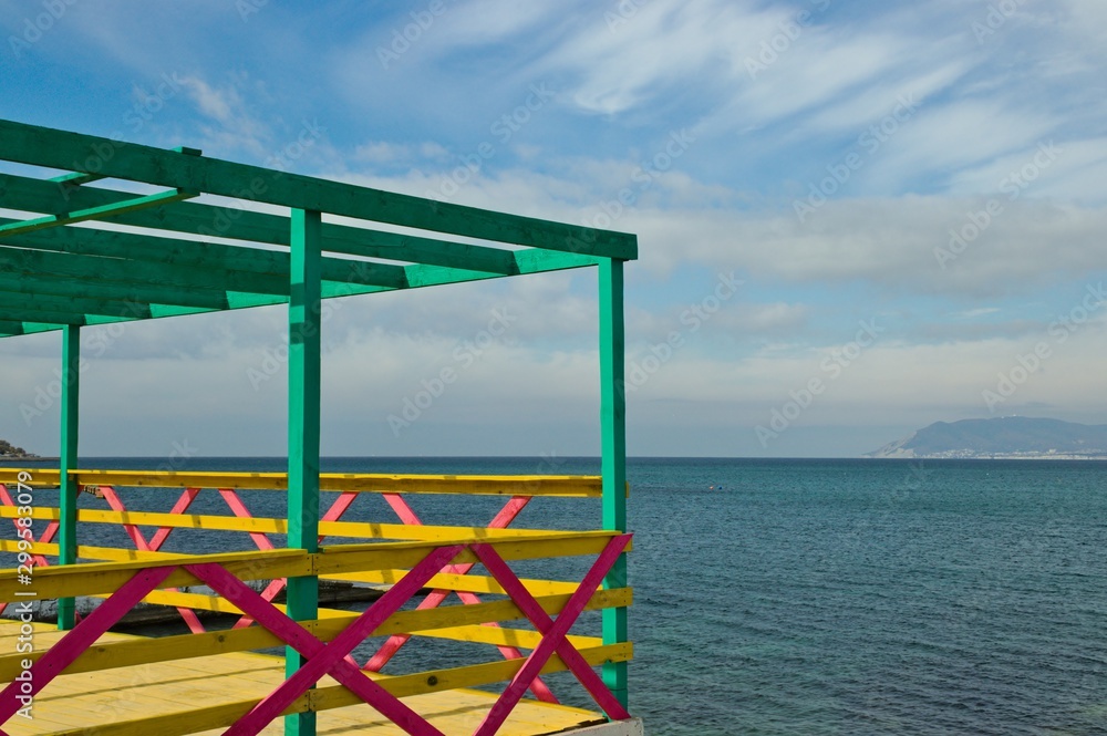 panorama of the Black Sea through a multi-colored fence