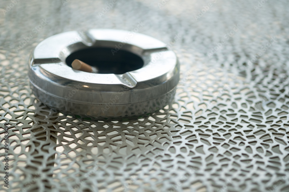 Dirty ashtray with cigarette stubs Dirty ashtray with cigarette stubs