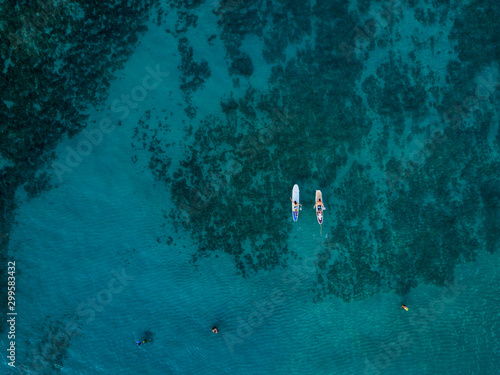 Aerial drone shot view of surfers in pacific ocean near Waikiki beach, Honolulu, Hawaii photo