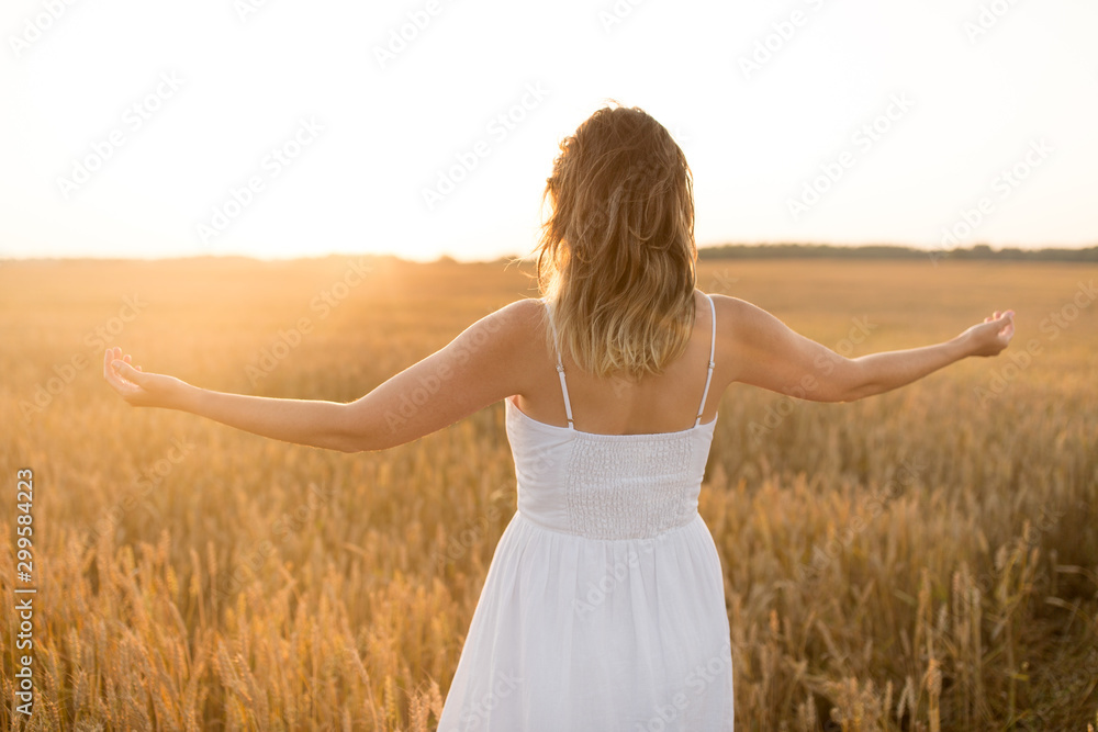 nature, people and happiness concept - happy young woman in white dress and enjoying freedom on cereal field in summer nature, people and happiness concept - happy young woman in white dress and enjoying freedom on cereal field in summer