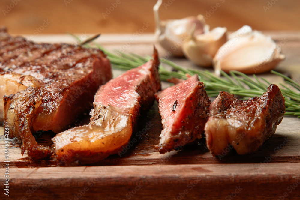 steak from beef, steak with vegetables, proper nutrition, healthy food,  a piece of boiled pork on a wooden board, presentation and serving, rustic style, vegetables for meat, 