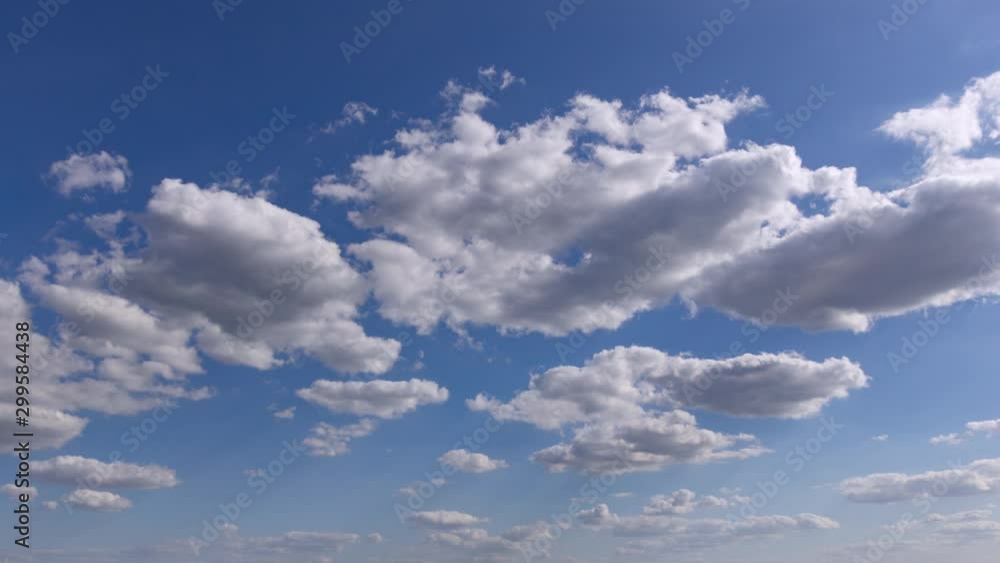 Time lapse of white fluffy clouds forming under a bright blue sky Time lapse of white fluffy clouds forming under a bright blue sky