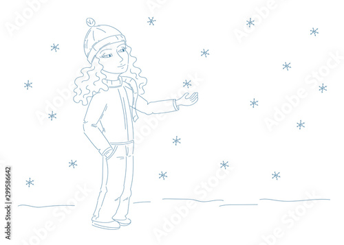 cute girl with cap and scarf catching snowflakes 