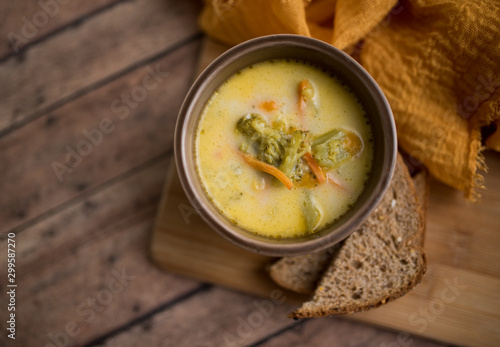 broccoli cheese soup served with toasted bread in a bowl