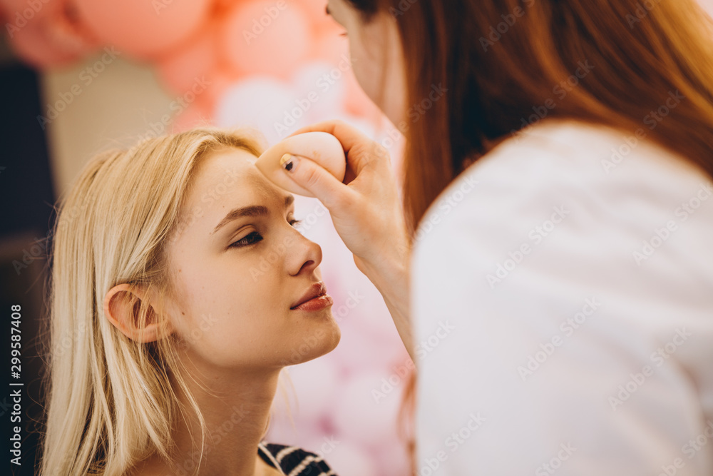 portrait of a young pretty girl visiting a cozy beauty salon with pink walls, mirrors, light window, where friendly staff make her makeup and hairstyle portrait of a young pretty girl visiting a cozy beauty salon with pink walls, mirrors, light window, where friendly staff make her makeup and hairstyle
