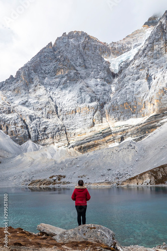 tourist at top of mountain at outdoors during a hike the summit of mountain peak. Success freedom and happiness achievement in mountains. Active sport concept